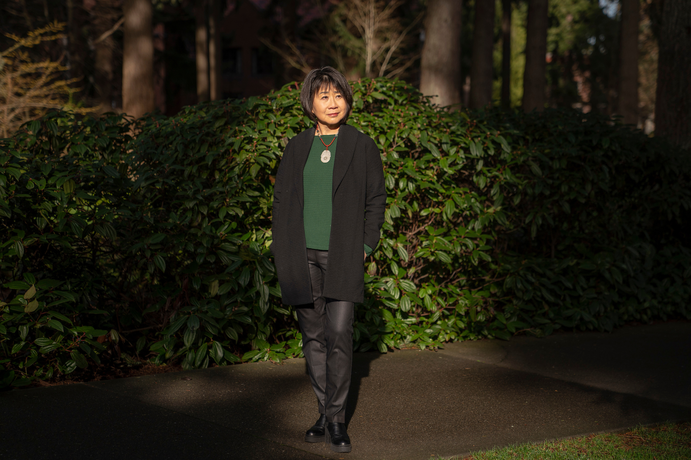 Lotus Perry stands outside on the campus of University of Puget Sound