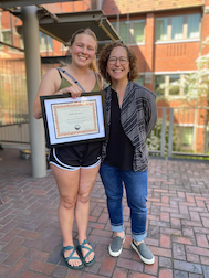 Megan Mooney receiving Alcorn award from Stacey Weiss.