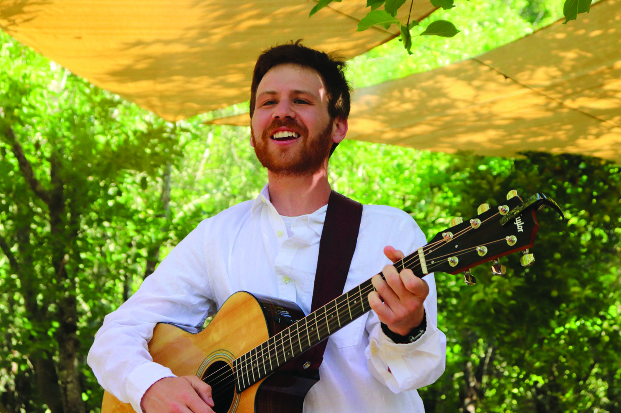 Gabriel Lehrman '16 plays the guitar while leading a summer camp.