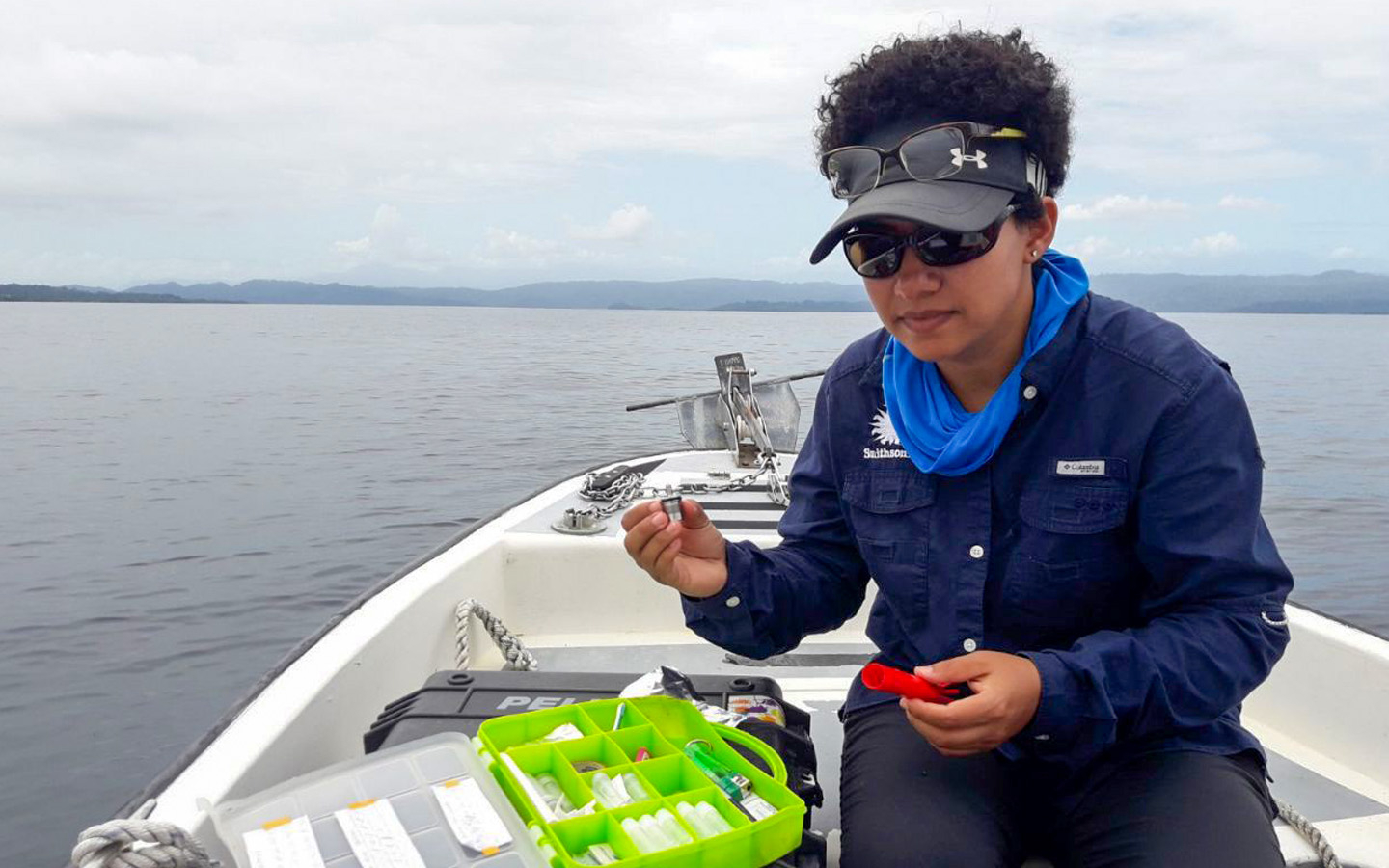 Student in a boat at sea working on sample materials 