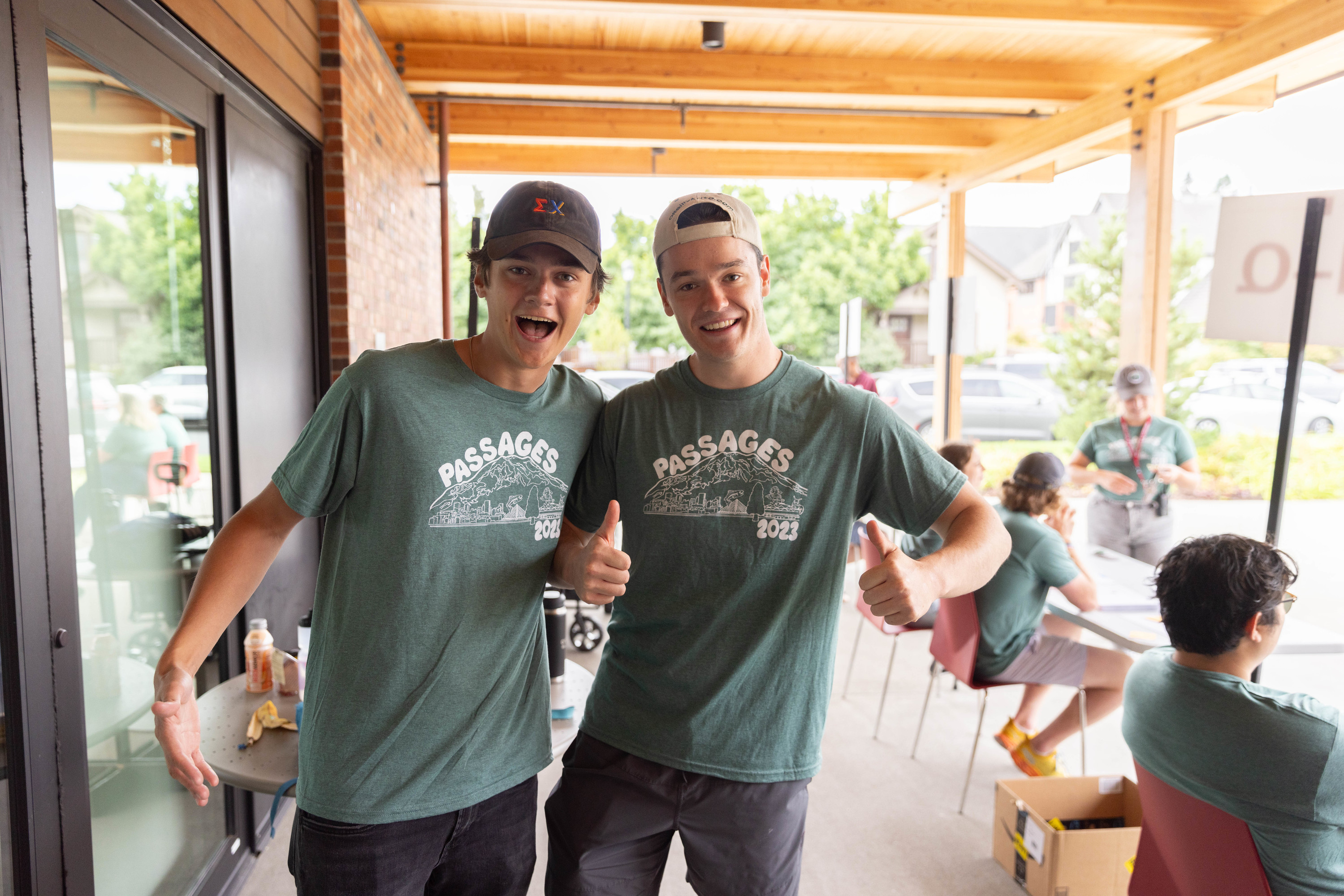 Two Passages Leaders giving a thumbs up to the camera during move-in.