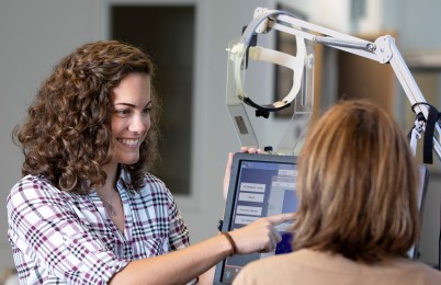 Two people looking at a screen.