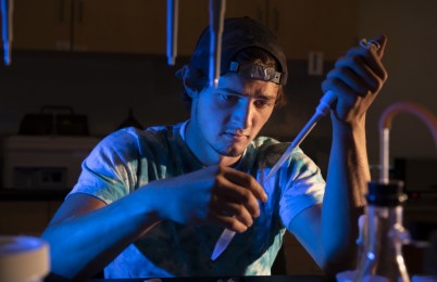 A person holding scientific equipment.