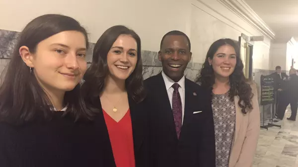 President Crawford and students working at legislative interns.