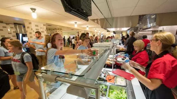 Students getting food in a cafeteria