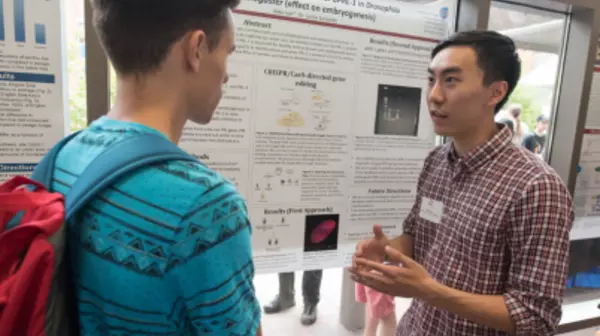 Two students standing at a research display board