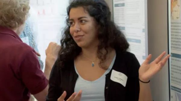 A student explaining a research display