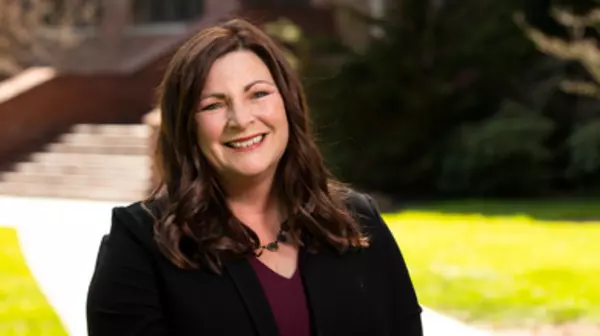 Tracy Doyle Headshot in front of the School of Music