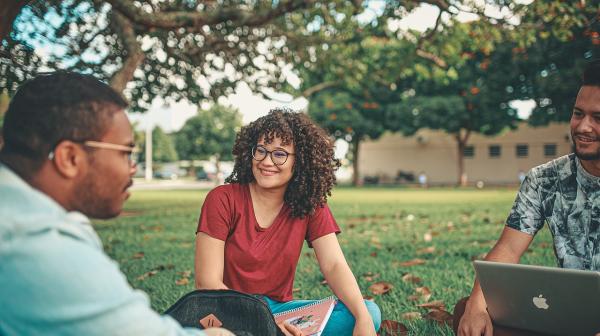 Group of people sitting on lawn