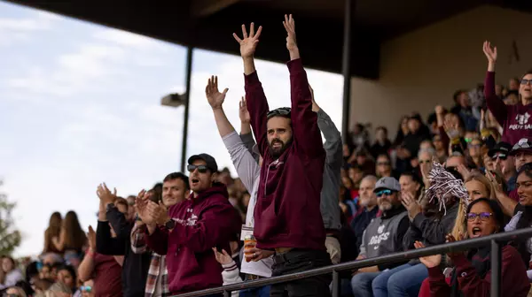 Fans cheering at Homecoming Football game