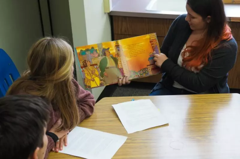 Student reading a picture book