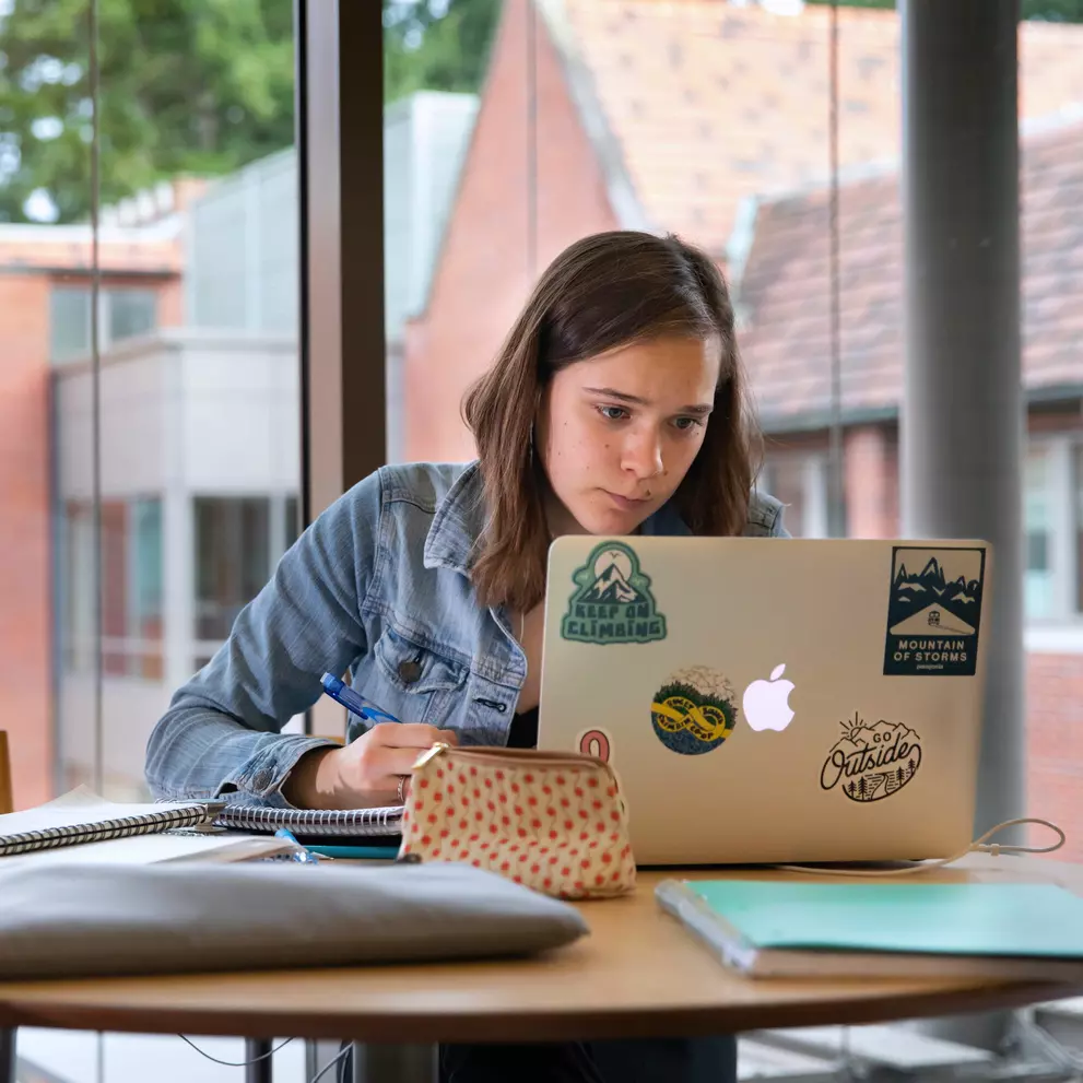 A student studies with a laptop in Thompson Hall.