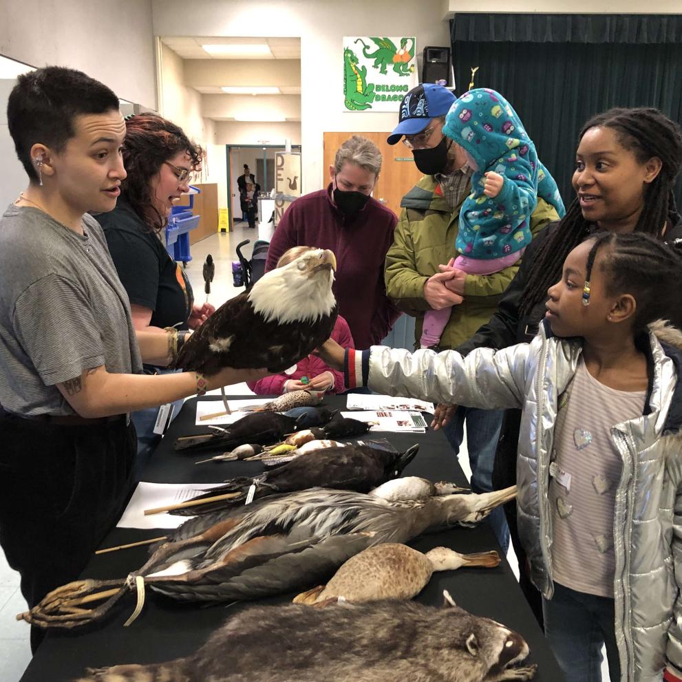 Student docents staff the museum table at an event.