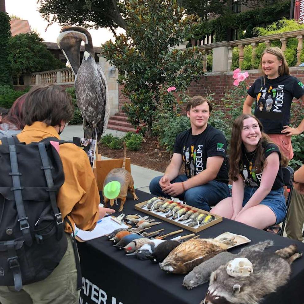 Student docents staff the museum table at LogJam.