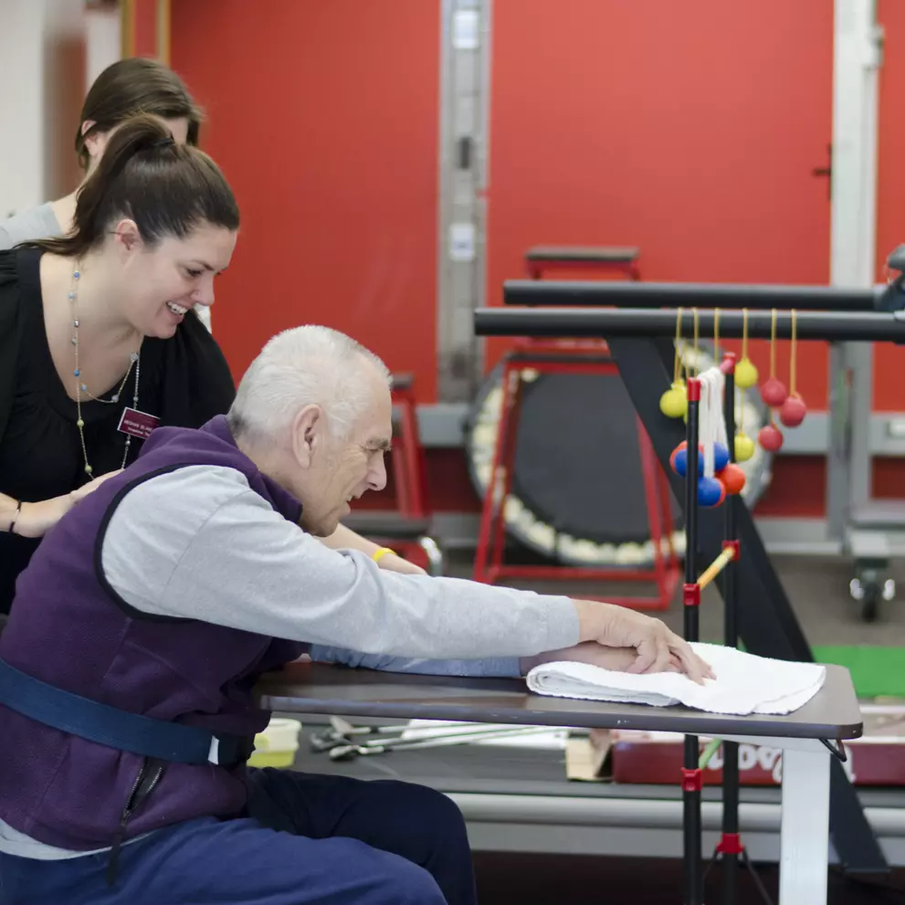 An OT student works with a patient in our teaching clinic.