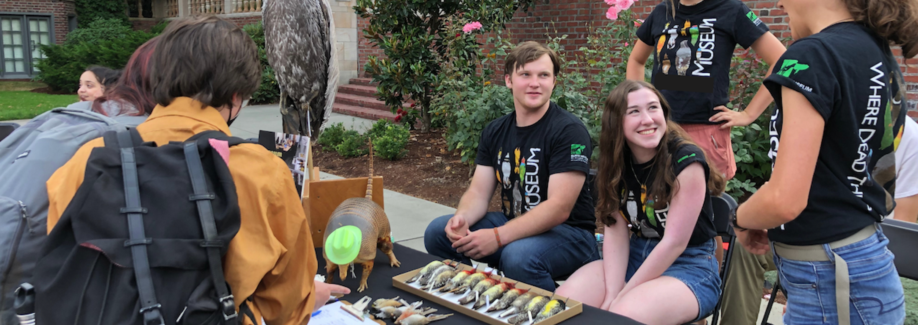 Student docents staff the museum table at LogJam.