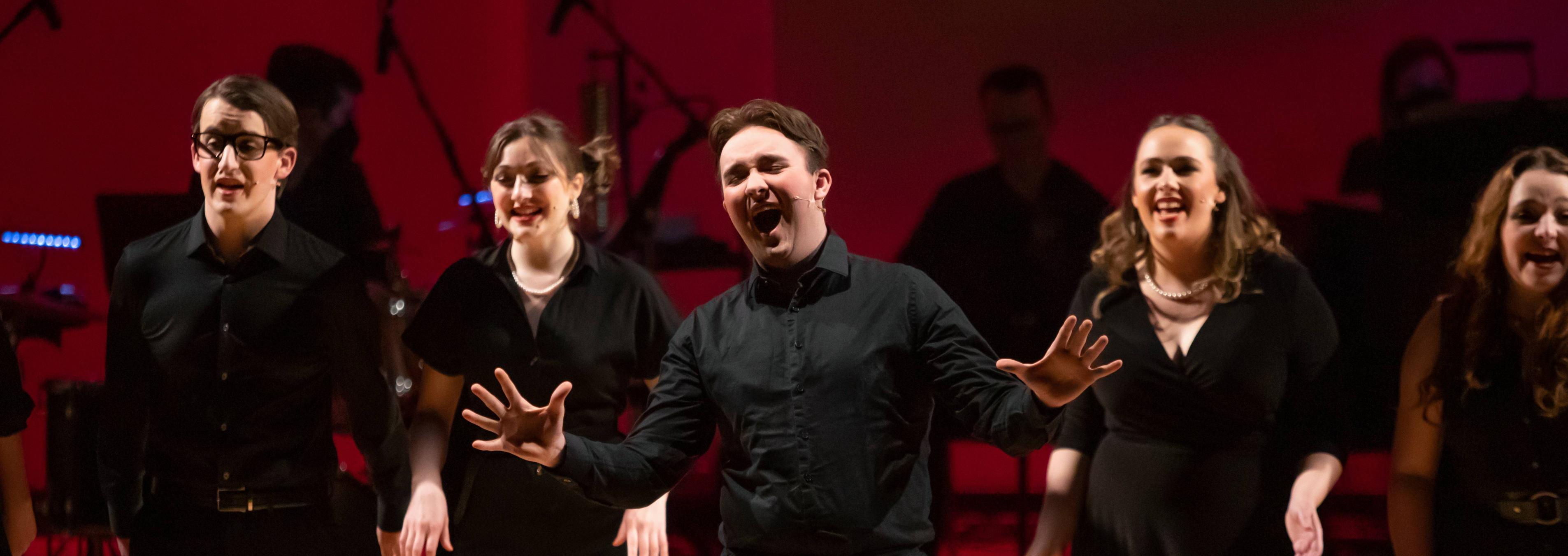 Students singing on stage