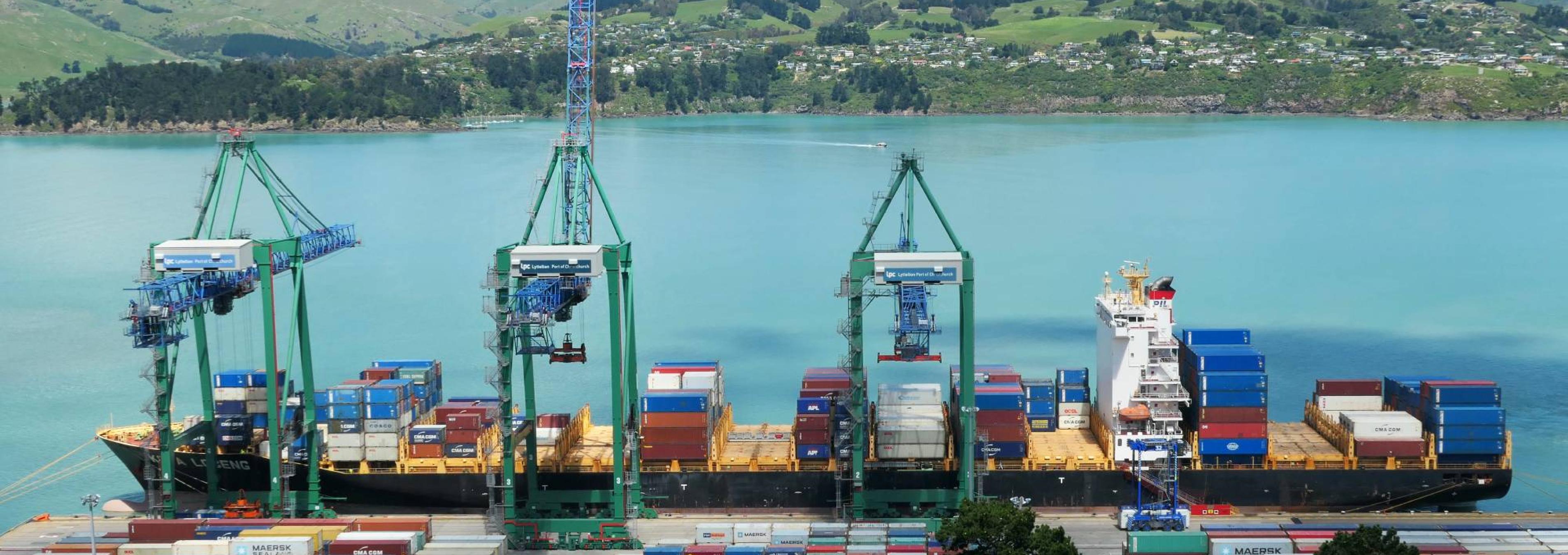 A water port with shipping containers being loaded