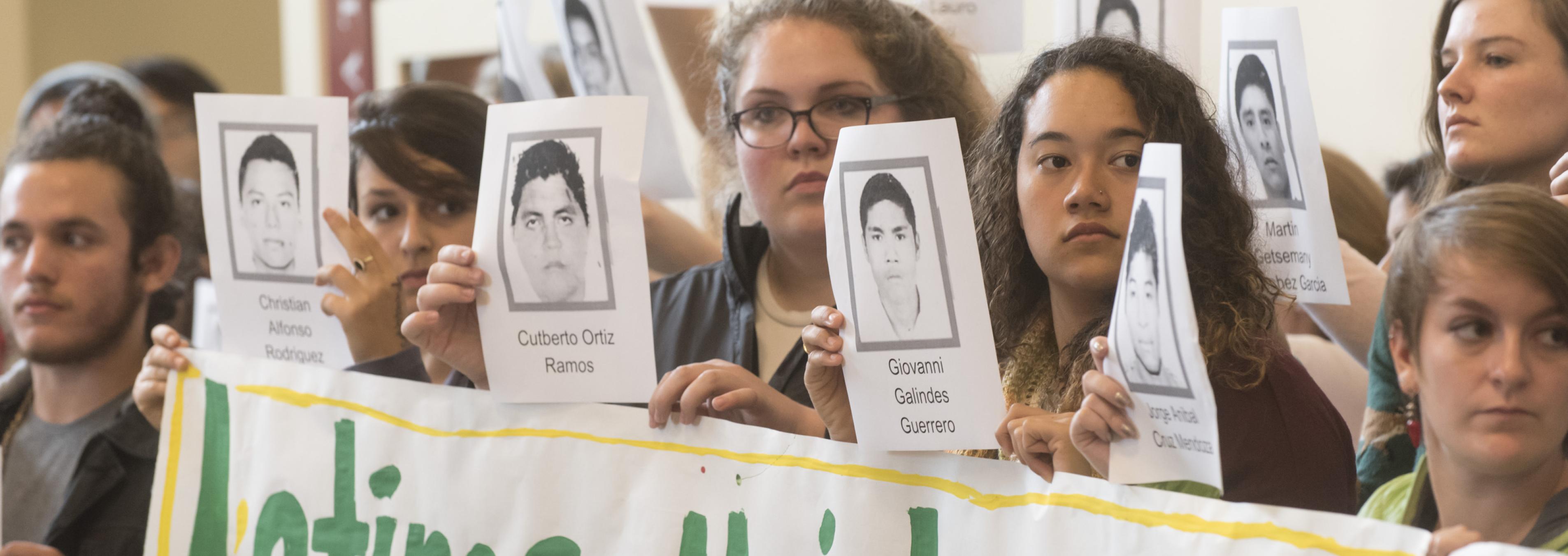 Students in Latinos Unidos stage a silent protest in the student center.