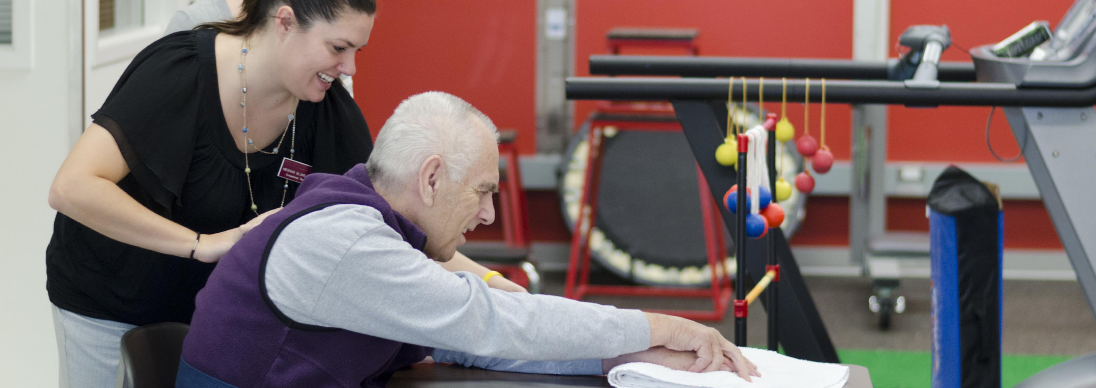 An OT student works with a patient in our teaching clinic.