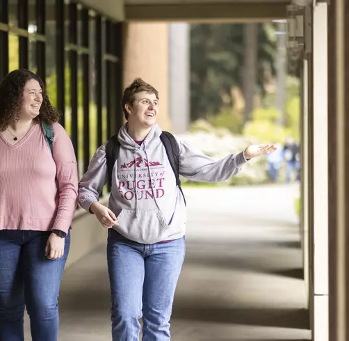 Two students walking on campus