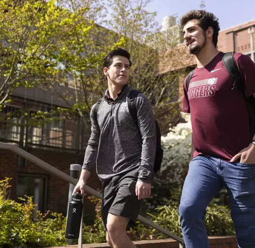 Two students walking on campus