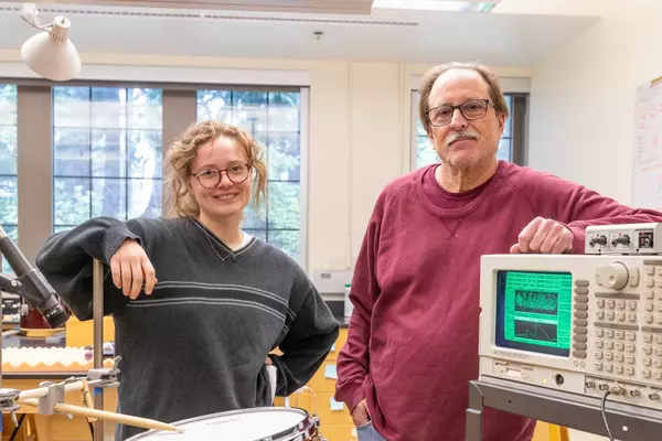 Professor and student with the equipment they used for a summer research project.