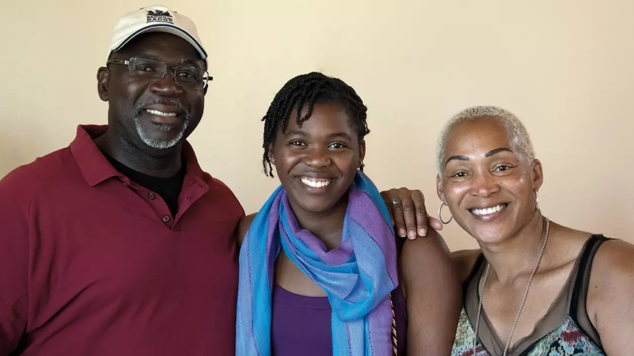 Three people smiling