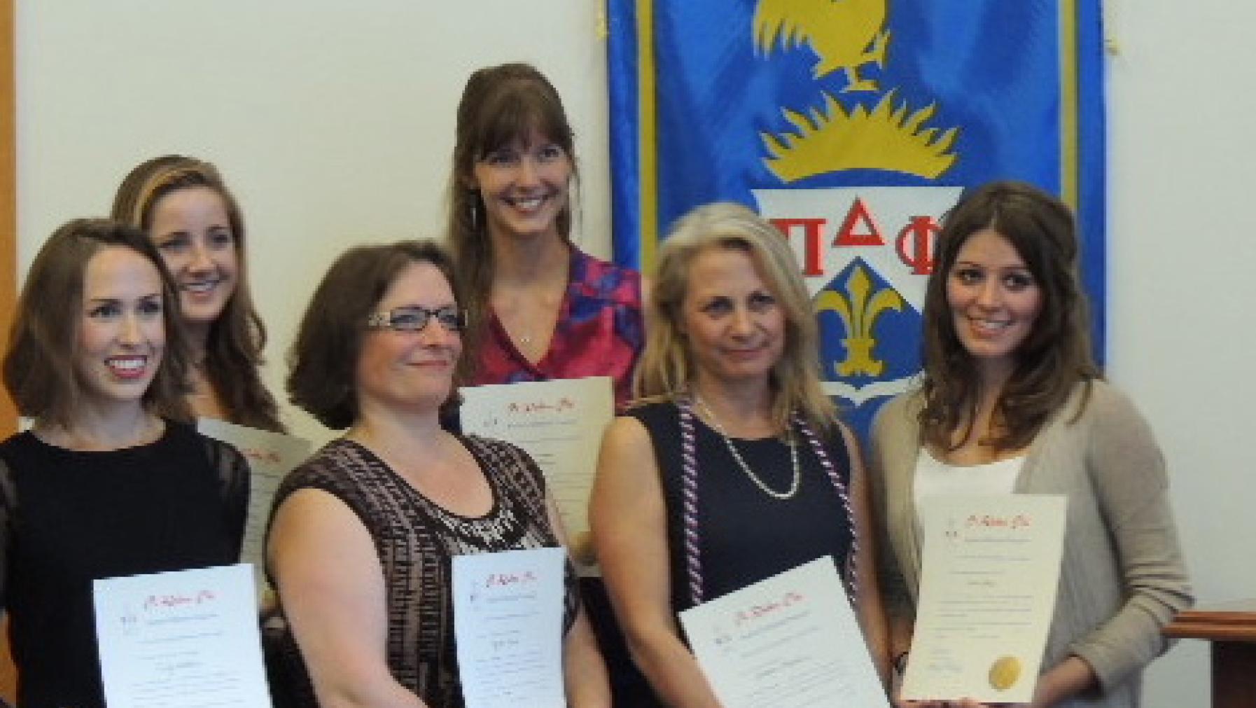 Students being inducted into the National French Honor Society, Pi Delta Phi.