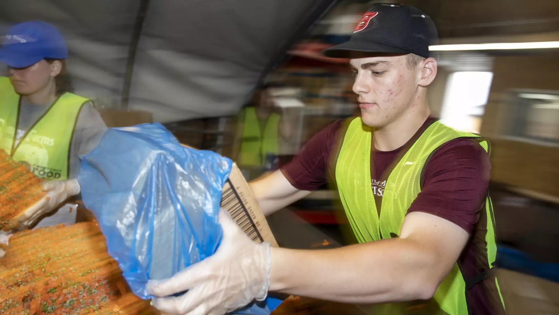 A person putting a box inside of a plastic bag