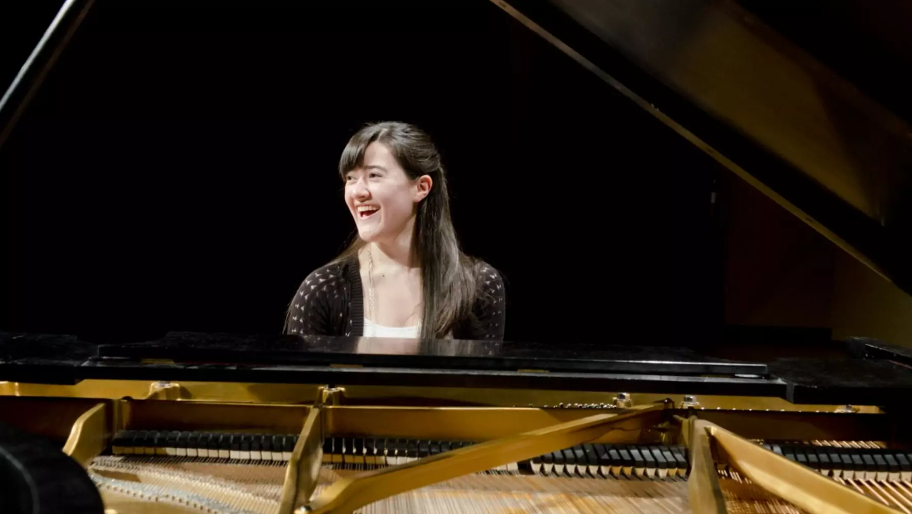 Woman seated at a piano