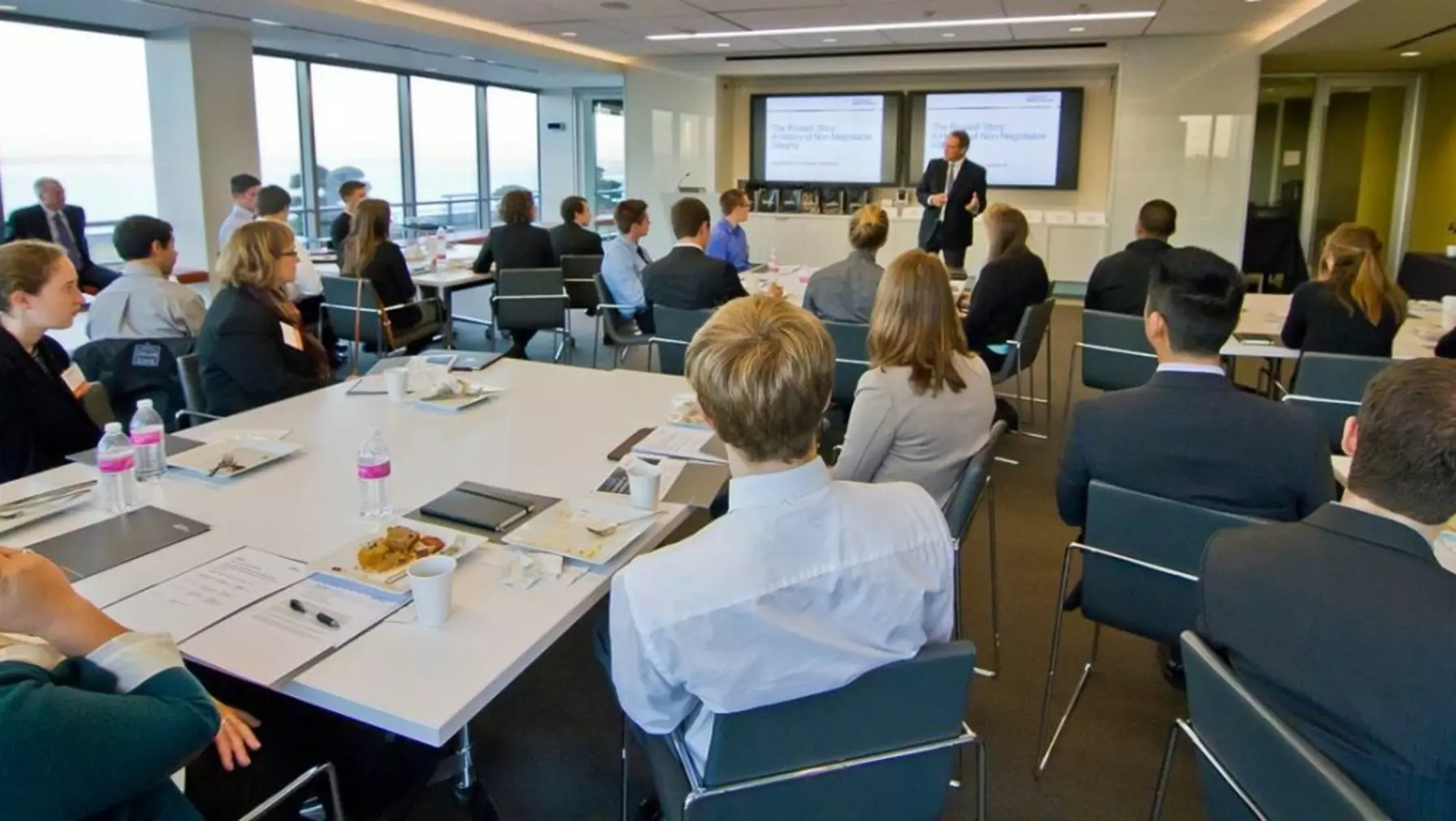 Seated people listening to a presentation