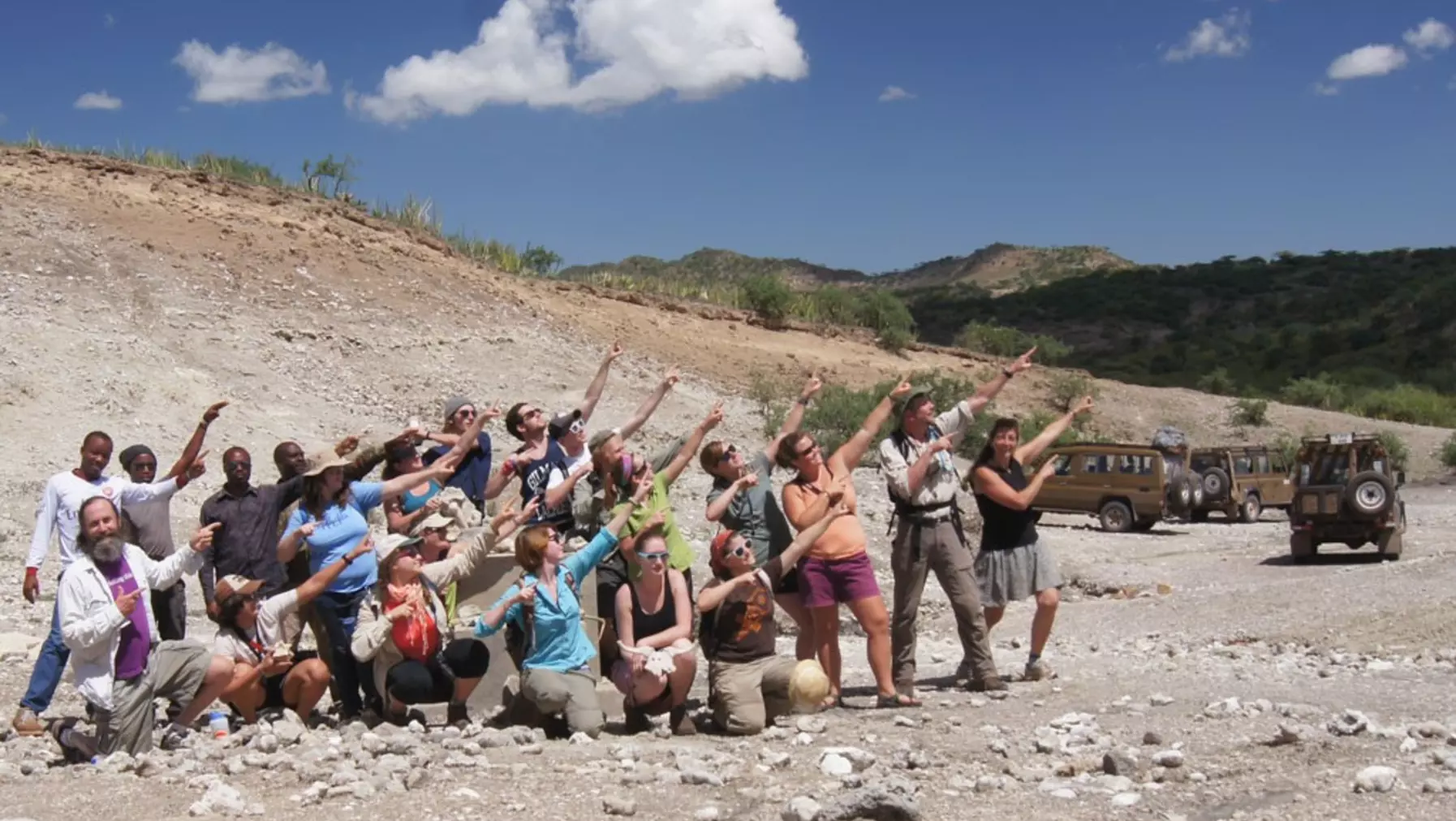 Students pointing upwards