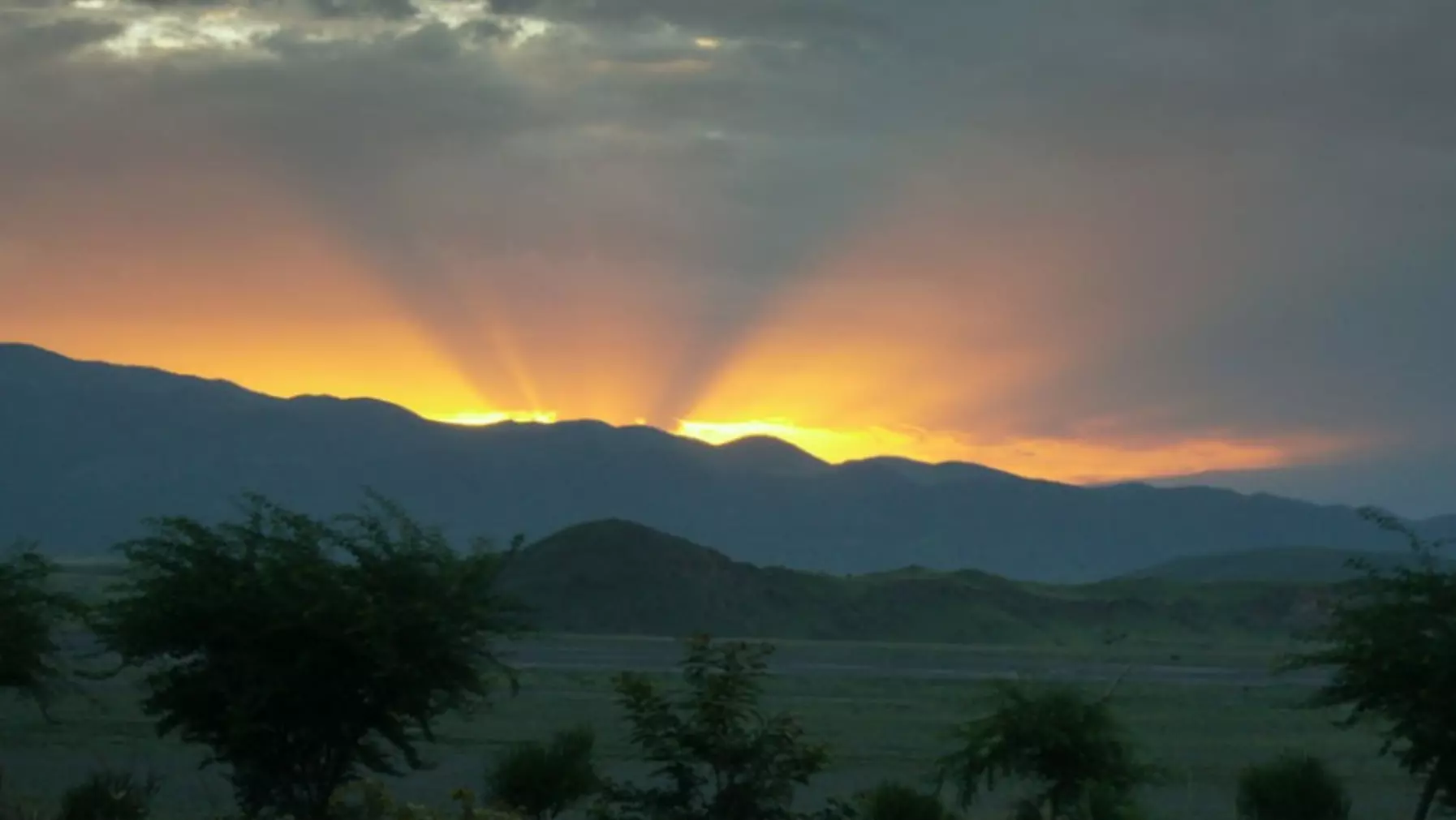 sun behind mountain