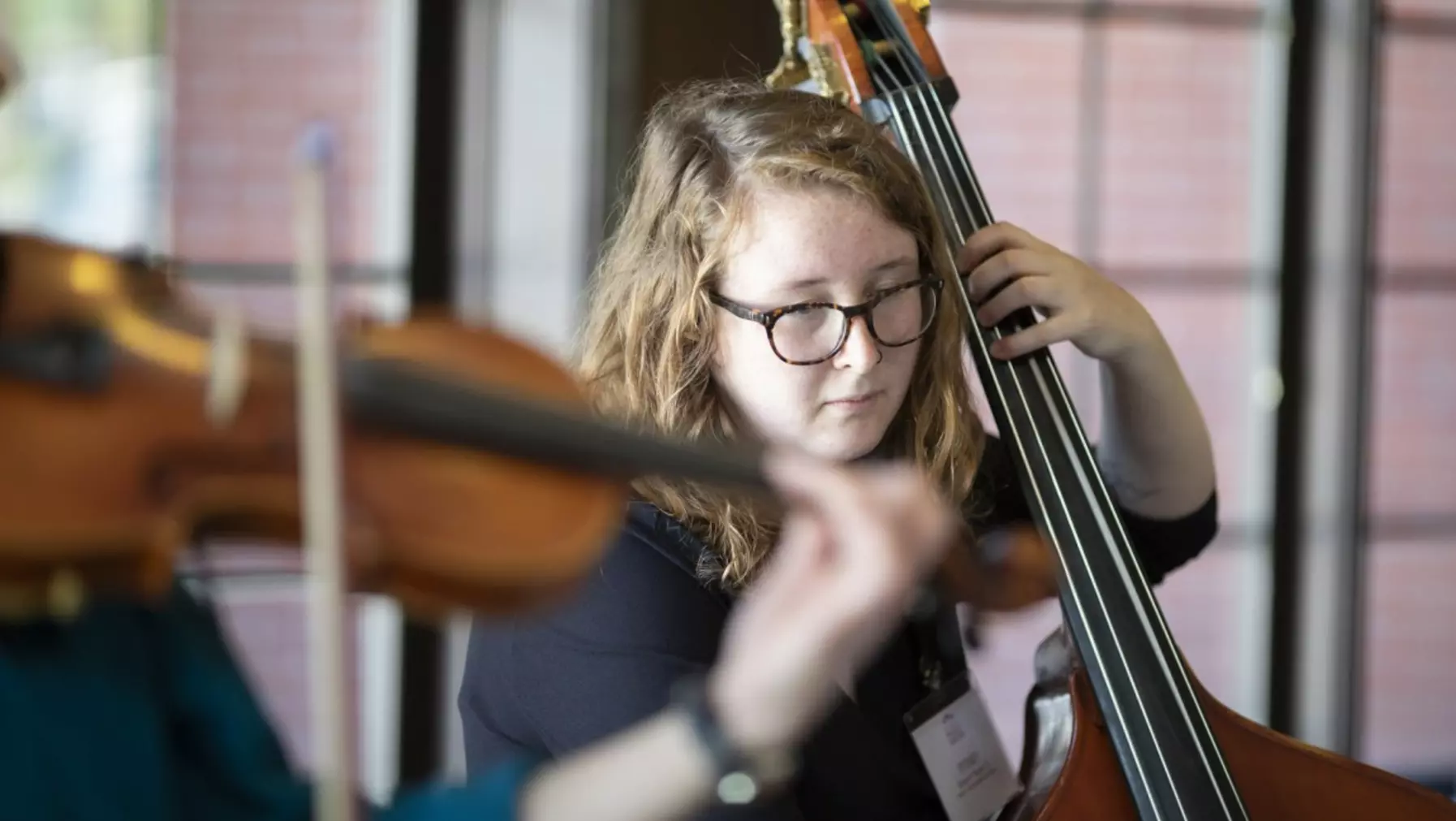 A person playing a double bass