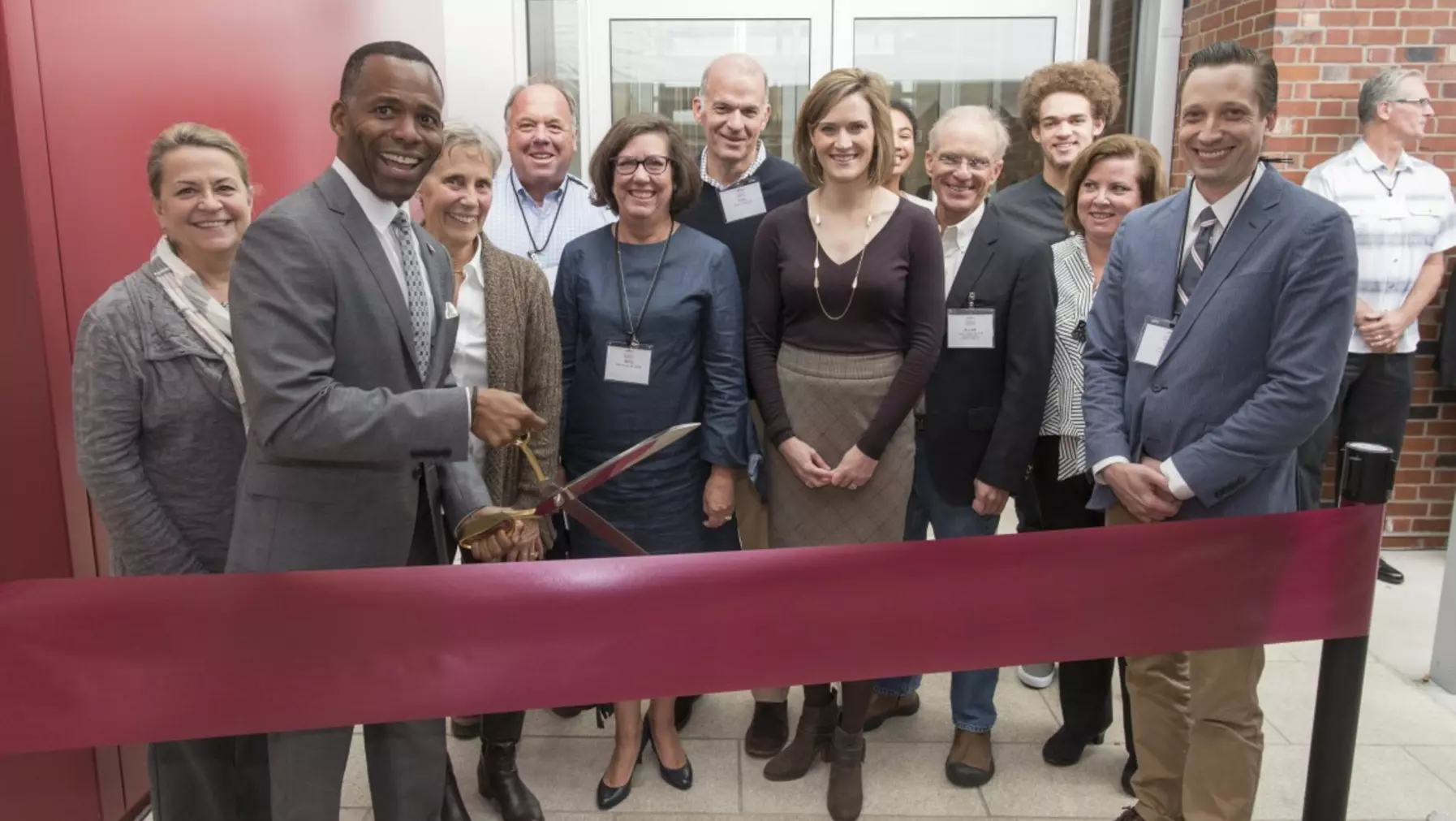 President Crawford and a group of onlookers at a ribbon cutting ceremony