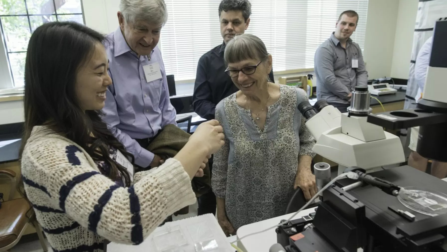 Group of people looking at research samples