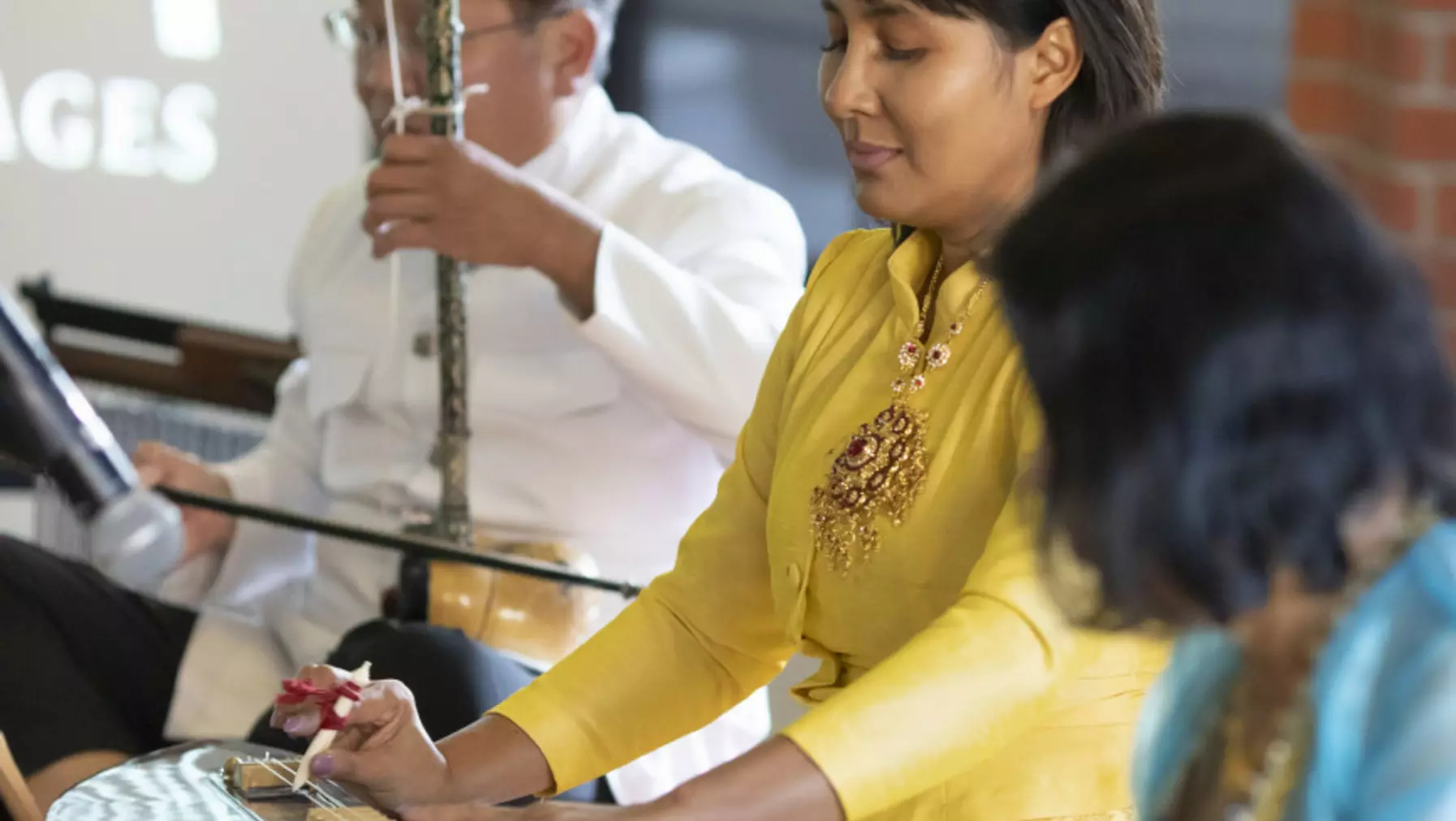 Musicians wearing traditional dress playing their instruments