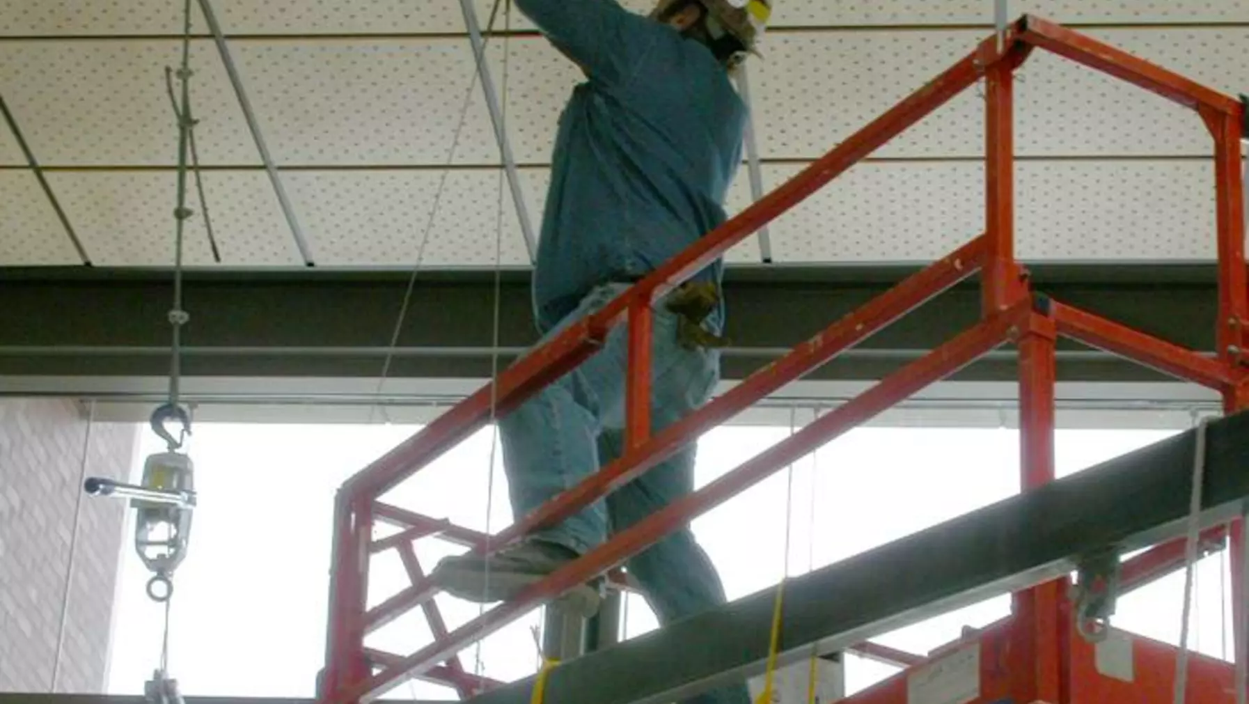 Jerry installing the 12 1/8" stainless steel hanging cables. He is 39 feet up. No need to worry about the cables. The recommended working load is about 340 lbs and breaking load is 1760 lb. The skeleton weighs about 270 lb and the head about 110 lbs. Each of eight cables on the skeleton carries only about 40 lbs and the four head cables carry about 27 lbs. When cabling was complete, Jerry and Isaac used the come-alongs to lower the whale into place in the cable harness. The alignment was perfect.