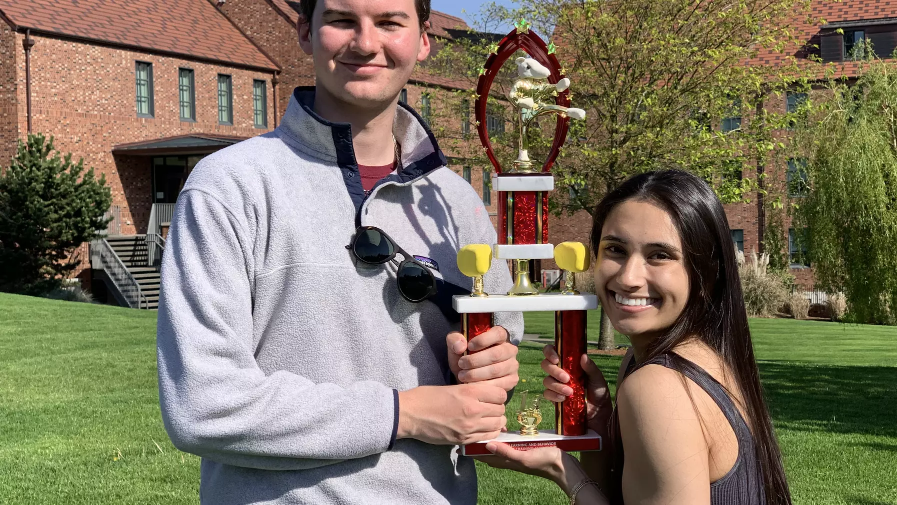 PSYC 311 rat training winners Hayley and Henry holding up a trophy