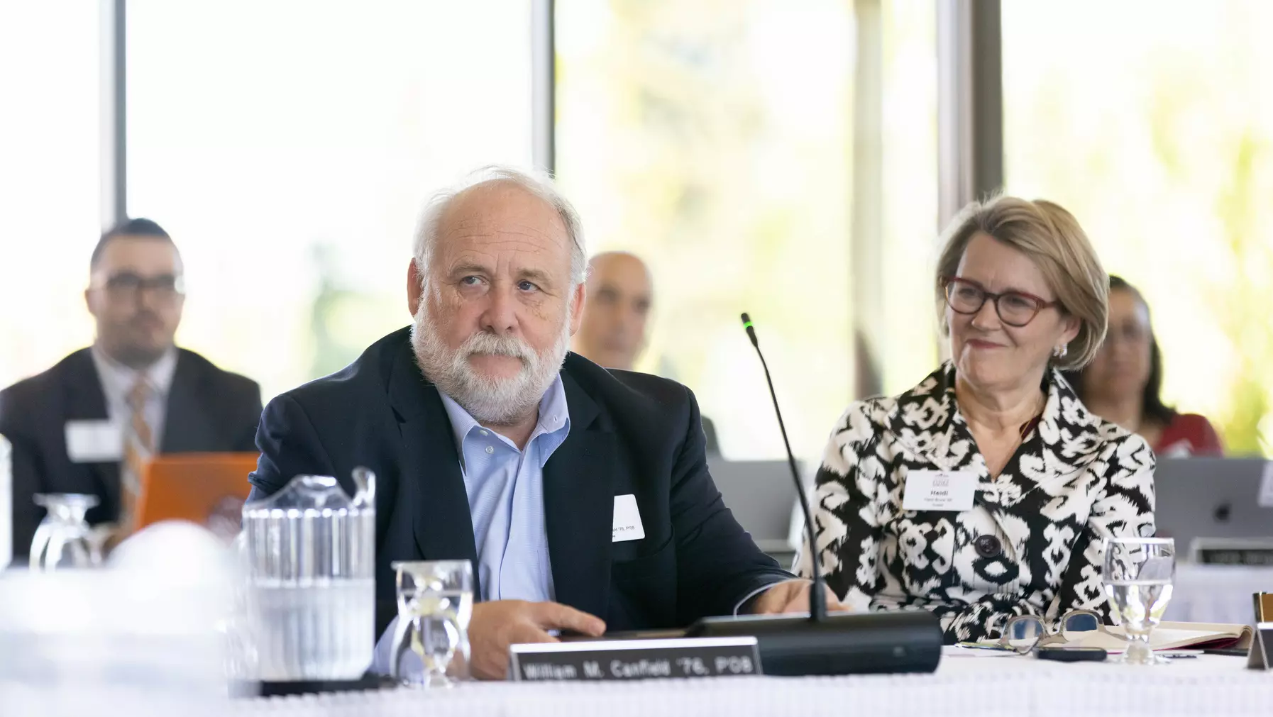 Trustee Bill Canfield '76 celebrates his final board meeting after multiple terms of dedicated service, as Trustee Heidi Brock '85 looks on.