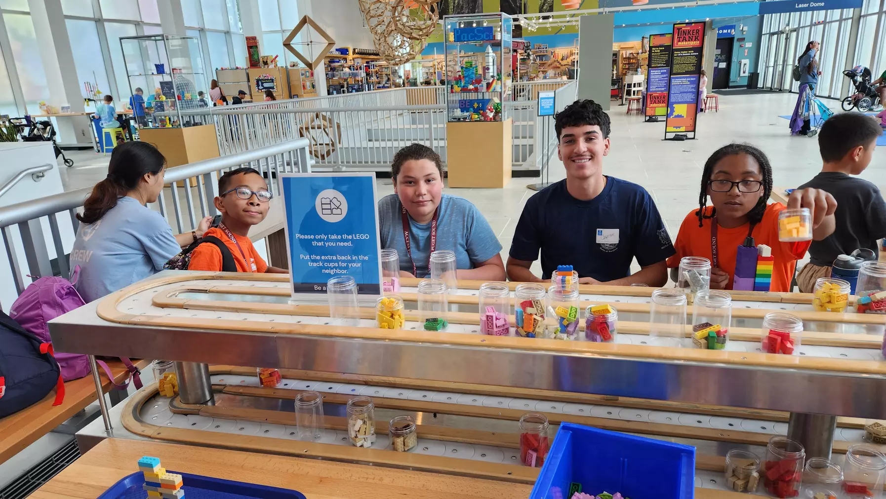 Students seated at a LEGO activity table