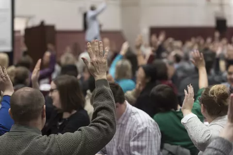 Man in crowd with raised hand