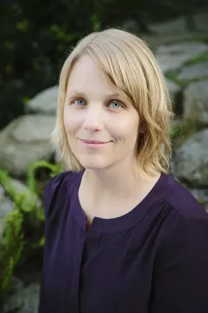 Tanya Erzen, associate professor of religion, spirituality, & society and director of crime, law and justice studies and gender & queer studies faces the camera in a purple blouse.