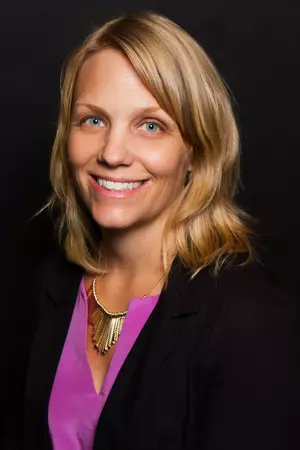 Tanya Erzen, associate professor of religion, spirituality, & society and director of crime, law and justice studies and gender & queer studies faces the camera in a purple blouse.