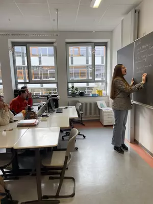 Khysa Gustafson writes on a blackboard