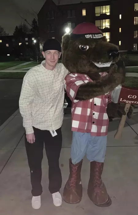 Photo of Tate posing with Grizz, the UPS mascot