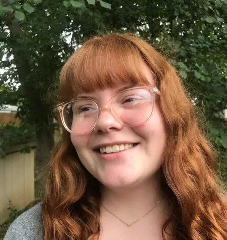 Portrait of Eliza Koch smiling and looking past camera