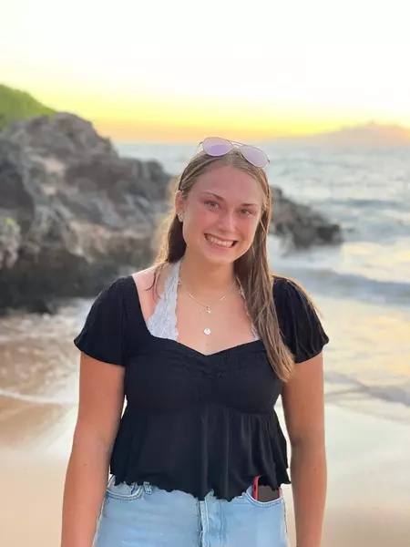 Photo of Paige Gerhart standing on a beach